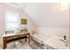 Attic bathroom featuring vintage furnishings, a clawfoot tub, and a pedestal sink at 527 Main St, Suwanee, GA 30024
