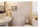 Charming powder room featuring vintage-style wallpaper and pedestal sink at 527 Main St, Suwanee, GA 30024