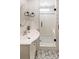 This bathroom features black and white patterned tile and a glass shower at 527 Main St, Suwanee, GA 30024