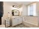 Elegant bathroom with black and white patterned tile, vanity and tub at 527 Main St, Suwanee, GA 30024