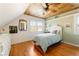 Cozy bedroom with wood-paneled ceiling, hardwood floors, and natural light at 527 Main St, Suwanee, GA 30024
