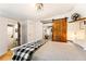 Modern bedroom with white walls, barn door, laundry and black-and-white blanket at 527 Main St, Suwanee, GA 30024