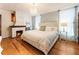 Beautiful bedroom with wood floors, brick fireplace, and large bed with nightstands at 527 Main St, Suwanee, GA 30024