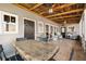 Covered patio with stone flooring and a wood ceiling perfect for entertaining at 527 Main St, Suwanee, GA 30024