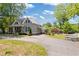 Charming gray home features a metal roof, covered front porch and a long driveway at 527 Main St, Suwanee, GA 30024
