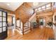Stunning foyer showcases wood paneled walls, staircase, and hardwood floors at 527 Main St, Suwanee, GA 30024