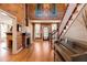 Grand foyer with wood floors, staircase, piano, and fireplace at 527 Main St, Suwanee, GA 30024
