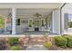 Inviting front porch with comfortable seating, ceiling fans, and brick steps at 527 Main St, Suwanee, GA 30024