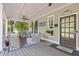 Inviting covered front porch with comfortable wicker seating and ceiling fan at 527 Main St, Suwanee, GA 30024