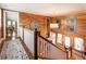 Elegant upstairs hallway featuring wood paneling, large artwork, and a chandelier at 527 Main St, Suwanee, GA 30024