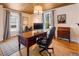 Comfortable home office with a wood ceiling, computer, classic desk, and rolling chair at 527 Main St, Suwanee, GA 30024
