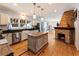 Bright kitchen featuring an island, stainless steel appliances, and a brick fireplace at 527 Main St, Suwanee, GA 30024