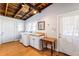 Bright laundry room with a washer and dryer, sink and cabinet, and a door to the outside at 527 Main St, Suwanee, GA 30024