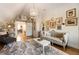 Attic space with hardwood floors, sofa and birdcage chandelier with a dressing room in the background at 527 Main St, Suwanee, GA 30024