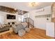 Open living space boasts hardwood floors, shiplap walls, and modern staircase to second floor at 527 Main St, Suwanee, GA 30024