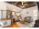 Comfortable living room with exposed brick wall, plush seating, and decorative ceiling fan at 527 Main St, Suwanee, GA 30024