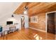 Bright home office with custom wood ceiling and walls plus hardwood flooring at 527 Main St, Suwanee, GA 30024