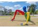 Public art sculpture in a park-like setting with manicured lawn, trees, and open green space at 527 Main St, Suwanee, GA 30024