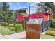 Welcome to Suwanee! A red caboose and information kiosk accent this landscaped sign at 527 Main St, Suwanee, GA 30024