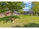 Expansive backyard featuring a fenced yard, mature trees, and a red outbuilding at 527 Main St, Suwanee, GA 30024