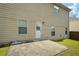 The backyard includes a concrete patio with a beige two-story house and a small, grassy area at 7328 Vigo Dr, Lithonia, GA 30058