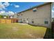 Expansive backyard featuring a well-maintained lawn and a privacy fence with trees and blue skies at 7328 Vigo Dr, Lithonia, GA 30058