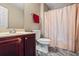 Bathroom features modern vanity, toilet, and shower with patterned curtain and a red towel at 7328 Vigo Dr, Lithonia, GA 30058