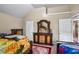 A bedroom featuring dual beds with floral sheets, wooden dressers and a mirrored vanity at 7328 Vigo Dr, Lithonia, GA 30058