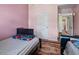 View of a bedroom featuring two beds, neutral carpet, dark wood trim and pink accent wall at 7328 Vigo Dr, Lithonia, GA 30058