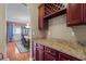 Butler's pantry featuring granite countertops, wine rack and custom cabinetry at 7328 Vigo Dr, Lithonia, GA 30058
