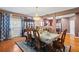 Elegant dining room featuring a chandelier, hardwood floors, and adjacent kitchen view at 7328 Vigo Dr, Lithonia, GA 30058