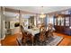 Open-concept dining area featuring a chandelier, hardwood floors, and open access to the kitchen at 7328 Vigo Dr, Lithonia, GA 30058