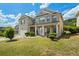 Two-story brick house with well-manicured lawn and front porch in a suburban setting at 7328 Vigo Dr, Lithonia, GA 30058