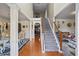Grand foyer with hardwood floors, staircase, and views into formal dining and living areas at 7328 Vigo Dr, Lithonia, GA 30058