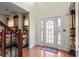 Bright foyer with hardwood floors, featuring a white front door and elegant wainscoting at 7328 Vigo Dr, Lithonia, GA 30058