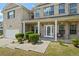 Inviting front porch featuring white columns and a walkway with lush green landscaping at 7328 Vigo Dr, Lithonia, GA 30058