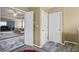 Hallway leads to the main bedroom and has open doorways and marble-patterned vinyl flooring at 7328 Vigo Dr, Lithonia, GA 30058