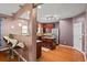 A kitchen with wood floors and stainless steel appliances adjacent to a breakfast bar with three bar stools at 7328 Vigo Dr, Lithonia, GA 30058