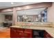 Spacious kitchen with granite countertops, stainless steel dishwasher and a clear view to the dining room and work area at 7328 Vigo Dr, Lithonia, GA 30058