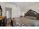 Bright main bedroom with high ceilings, featuring a large bed with patterned duvet and ornate headboard at 7328 Vigo Dr, Lithonia, GA 30058