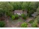 Aerial view of the home showing the mature trees, private yard, and driveway at 8315 Nicholson Rd, Cumming, GA 30028