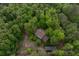 An aerial shot showcasing the secluded home surrounded by lush, green trees at 8315 Nicholson Rd, Cumming, GA 30028