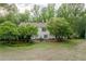 Well-maintained backyard featuring a green lawn, mature trees and patio area at 8315 Nicholson Rd, Cumming, GA 30028
