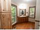 Bright bathroom with wood finishes, a corner sink, and a window to the outside at 8315 Nicholson Rd, Cumming, GA 30028