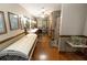 Large bathroom with double vanities, hardwood floors, tanning bed, and multiple shower stalls for ultimate convenience at 8315 Nicholson Rd, Cumming, GA 30028