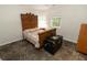 Quaint bedroom with vintage bed, window views, dark trunk and decorative floral carpet at 8315 Nicholson Rd, Cumming, GA 30028