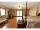 Bright bedroom featuring a four poster bed, hardwood floors and large windows at 8315 Nicholson Rd, Cumming, GA 30028