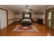 Large bedroom featuring wood floors, area rug, and bright light from large windows at 8315 Nicholson Rd, Cumming, GA 30028