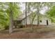 Inviting home tucked among mature trees and featuring a covered porch, creating a serene, private setting at 8315 Nicholson Rd, Cumming, GA 30028