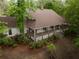 Charming home featuring a cozy, covered porch perfect for enjoying the serene wooded surroundings at 8315 Nicholson Rd, Cumming, GA 30028